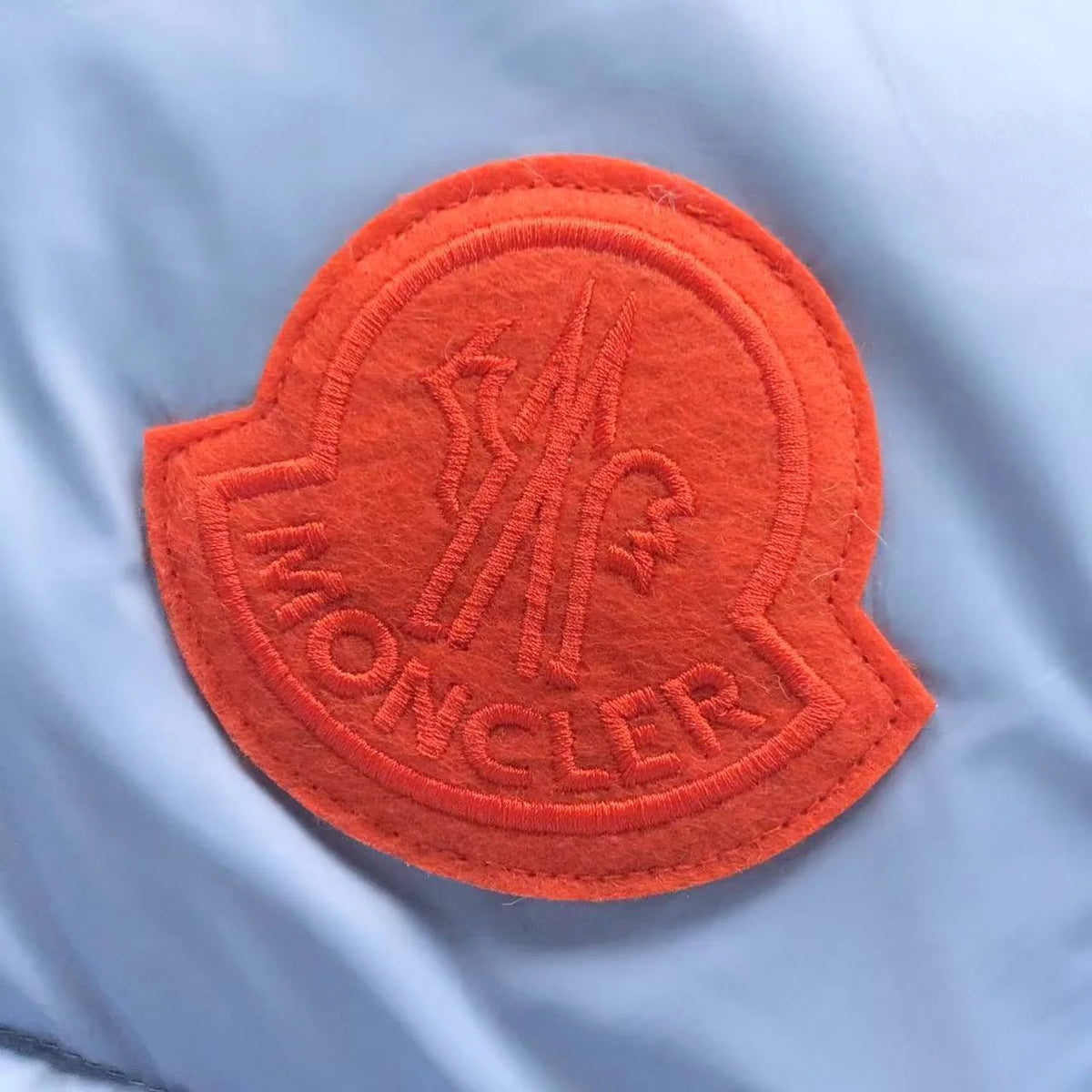 Moncler Light Blue Hooded Quilted Puffer Jacket with Orange Logo